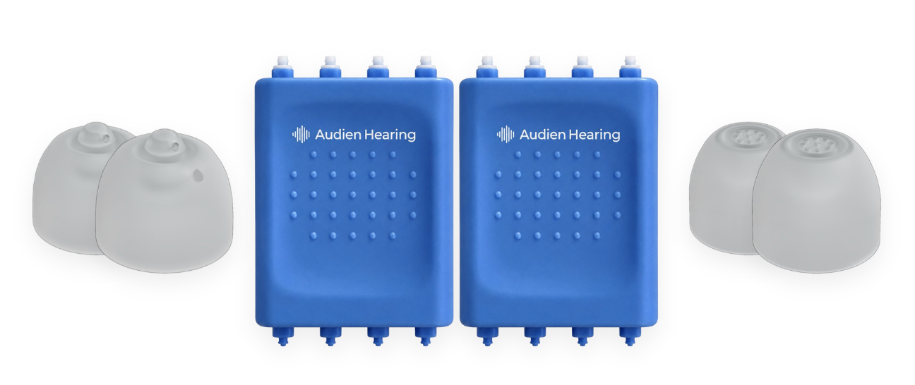 Two blue Audien Hearing devices with gray earpieces on a white background