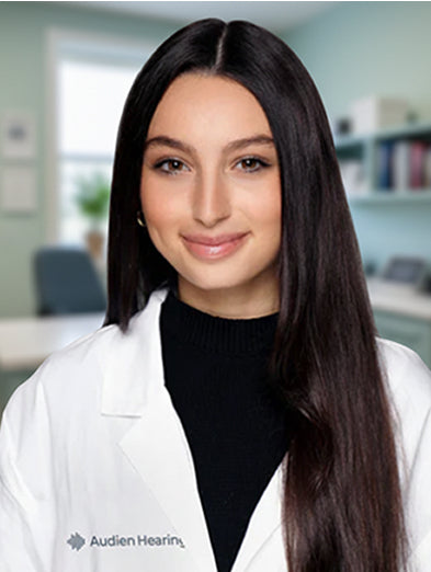 Audien Hearing specialist in a white lab coat in an office setting